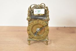 An electric mantle lantern clock, having chapter ring with Roman numerals, engraved to back 'Smith's