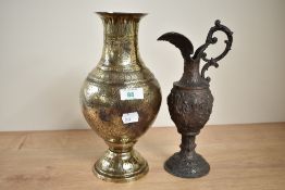 An early 20th century Middle Eastern brass vase of lobed form, decorated with hunting scenes, h28.