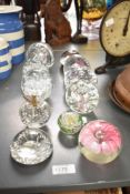 A group of transparent glass paperweights, to include an apple paperweight, flower paperweight