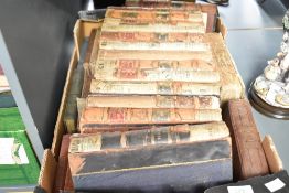 A box containing various 19th century Dickens novels, approx. 24