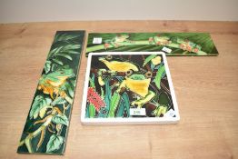 A ceramic frog wall plaque of square form, W 20cm x L 20cm, sold together with two other wall