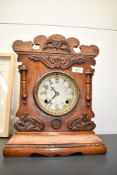 A late 19th century 'Newhavon, USA' oak cased 8 - day mantel clock having brass dial and carved