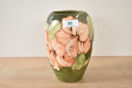 A Moorcroft pottery Hibiscus pattern pottery vase of ovoid form, decorated with pink floral