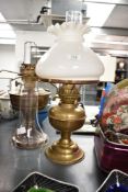 An early 20th century brass oil lamp complete with glass chimney and shade, h46cm, sold together
