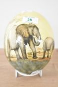 A blown Ostrich egg, hand painted depicting a heard of African elephants, h16cm