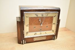 An Art Deco style oak cased mantel clock having brass dial and Roman numerals, L29cm