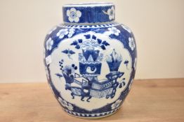 A large Chinese blue and white ginger jar and cover hand painted with prunus blossom and precious