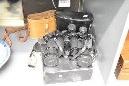 A pair of Pathescope binoculars having coated optics and 20 x 50 field vision, sold together with to