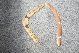 An Australian wooden boomerang having carved figures and traditional aboriginal patterns, L51cm,