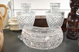 A pair of early 20th century Regency style cut glass lidded urns, having egg shaped body and