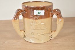 A large Victorian 3 handled Royal Doulton Lambeth style stoneware tyg, the handles in the form of