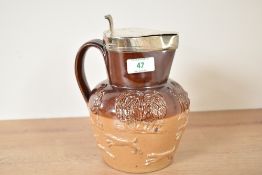 A Victorian Royal Doulton Lambeth style stoneware jug having silver top lid dated for Sheffield c.