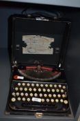 An early 20th century Remington portable typewriter in black with carry case, W27cm