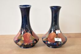 A pair of Moorcroft pottery Pomegranate pattern bottle vases, painted signature and impressed