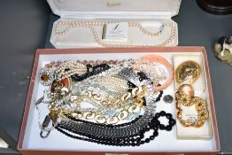 An assortment of costume jewellery, including beaded necklaces, faux pearls, brooches and paste