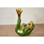 A green ceramic frog on back with legs in air, 15cm x 22cm