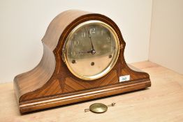 An early 20th century mahogany mantel clock having Westminster chimes, decorated with exotic wood
