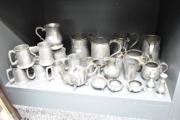 A large quantity of pewter tankards, largest H16cm, sold together with a pewter tea pot and milk jug