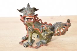 A Chinese cast and painted metal Foo dog censor, h11.5cm
