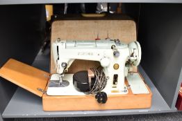 A cased singer sewing machine, label to side for 'The Singer Manufacturing Co', L50cm