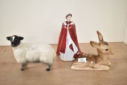 A Royal Worcester porcelain figurine of Queen Elizabeth, h23cm, sold together with a ceramic fawn