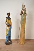 A tall resin sculpture of an African woman clutching a water vessel, h41cm, sold together with a