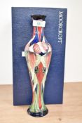 A Moorcroft potteryTrinity pattern pottery vase, decorated with floral patterns on a cobalt blue