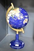 A rotating stone sample globe, the countries inlaid using semi-precious gemstones, 47cm