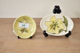 A small Moorcroft pottery Hibiscus pattern pin dish, decorated with leaf on a yellow ground, L8cm,