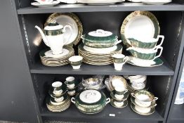 A Royal Stafford Bone China dinner service, decorated with gold colour edges and floral patterns