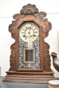 A late 19th century Ansonia (USA) Gingerbread clock having single gong chime, h56