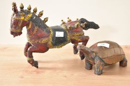 An early 20th century carved horse, possibly Indian, hand painted in red and yellow colour, L31cm,