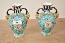 A pair of Crown Derby urn vases having gilded twin mask handles, decorated with floral patterns on a