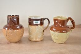 A Victorian Doultan Lambeth stoneware pitcher having hound handle and decorated with hunting