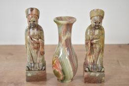 A pair of Chinese carved hard stone Confucius style figures, displayed on a square base seen