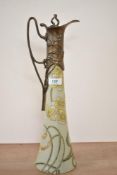 An attractive Art Nouveau style metal mounted Ewer, decorated with floral patterns on a green
