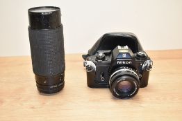 A Nikon 'EM' camera with protective case and detachable lens