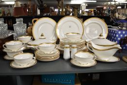 A Royal Doulton bone china 'Royal Gold' pattern dinner service, decorated with a gold colour edge
