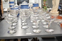 A set of 23 Babycham glasses, having gilt colour rims with yellow baby logo, h10cm