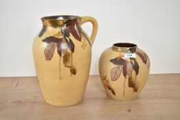 An early 20th century Bristol pottery pitcher, hand coloured with floral patterns, impressed mark to