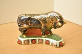 A Royal Crown Derby bone china Bull paperweight, having Imari style decoration and silver coloured