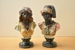 A pair of 20th century continental pottery, blackamoor busts, the male with previous damages to