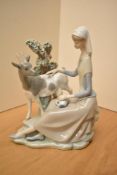 A Lladro porcelain figure group, 'Girl Shepherdess' model number 4570, measures 25cm.