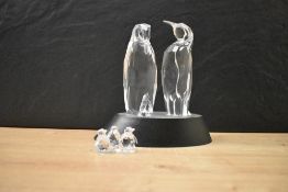 A Swarovski Crystal Penguin family scene, complete with display stand and boxes etc.