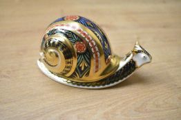 A Royal Crown Derby limited edition bone china Garden Snail paperweight, having Imari style
