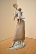 A Lladro porcelain figure group 'Mother and Child' model number 4710, measures 35cm.