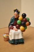 A Royal Doulton bone china figurine 'Old Balloon Seller', model number HN 1315, measuring 20cm.