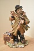 A large Capodimonte porcelain tramp figurine, measuring 30cm tall. Having damage to fingers and