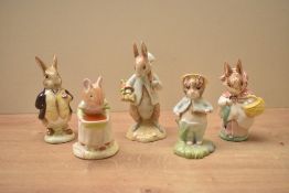 A group of five Beatrix Potter studies by Royal Doulton, Royal Albert and Beswick pottery comprising