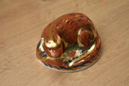 A Royal Crown Derby Otter paperweight, having Imari style decoration and gold coloured stopper,